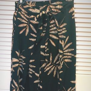 Black ankle-length pants w/orange/white leaf desgn